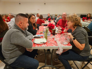 People at a table talking to each other.